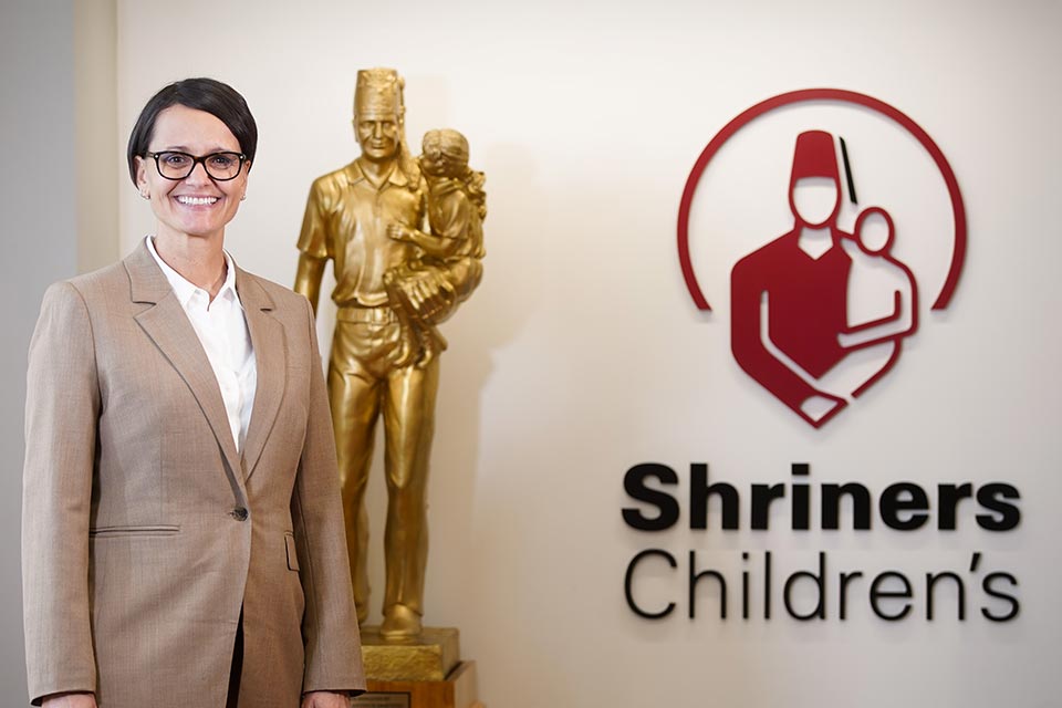 female burn care provider, statue, Shriners Children's logo