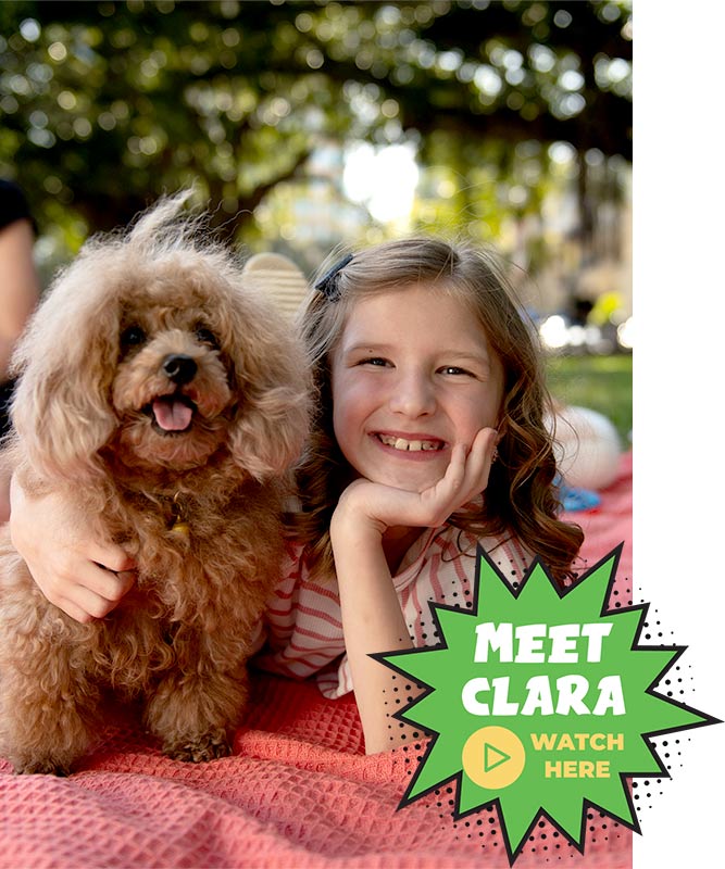 Patient smiling with dog; Meet Clara; Watch Video