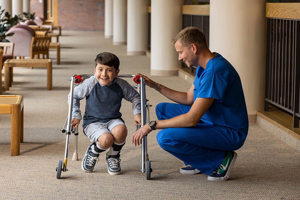 male provider and male orthopedic patient with walker