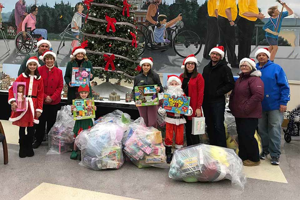 Volunteers with bags of toys for donation.