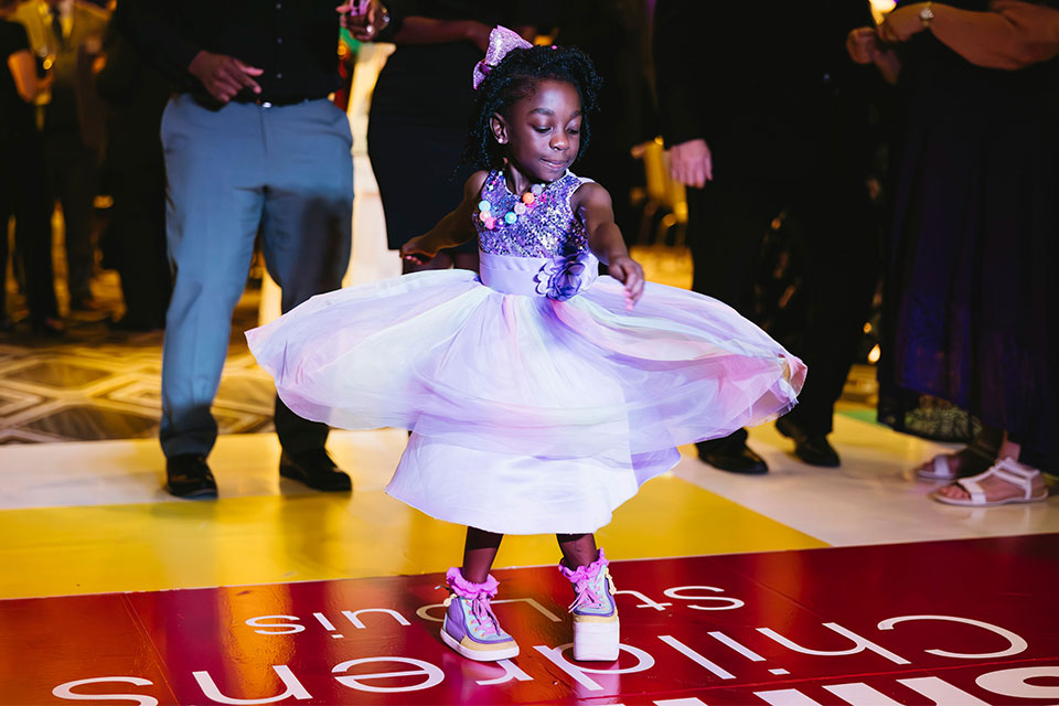 Patient Camille dancing in a purple dress.