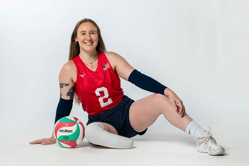 Bethany sitting on floor with volleyball