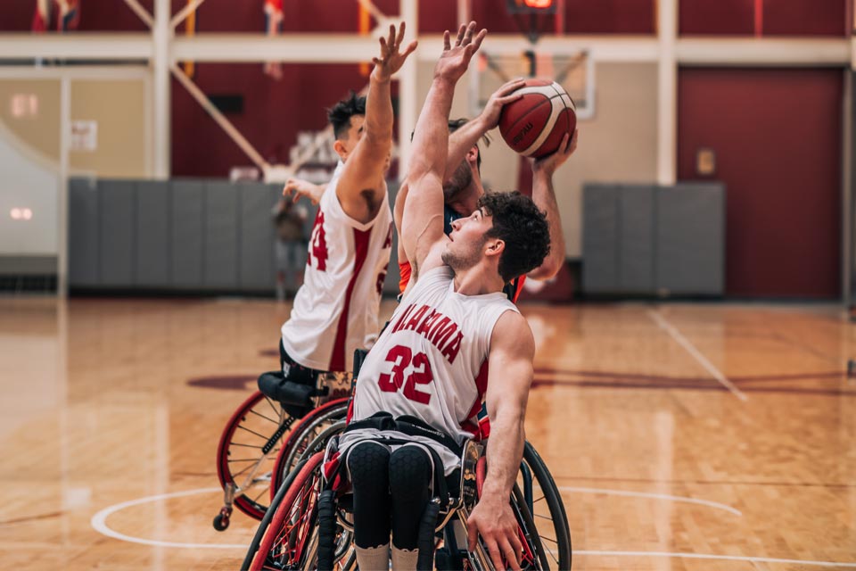 three wheelchair basketball players on court