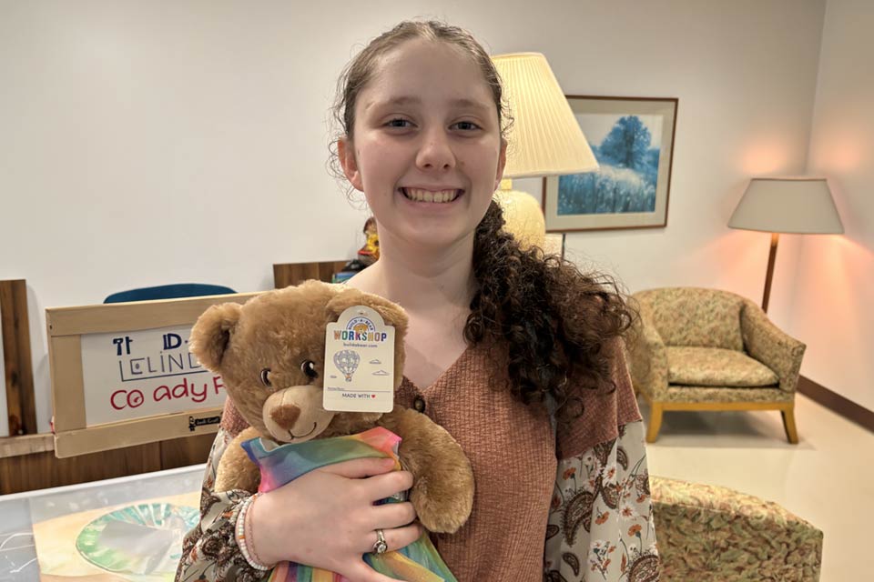 orthopedic patient Alysa holding teddy bear