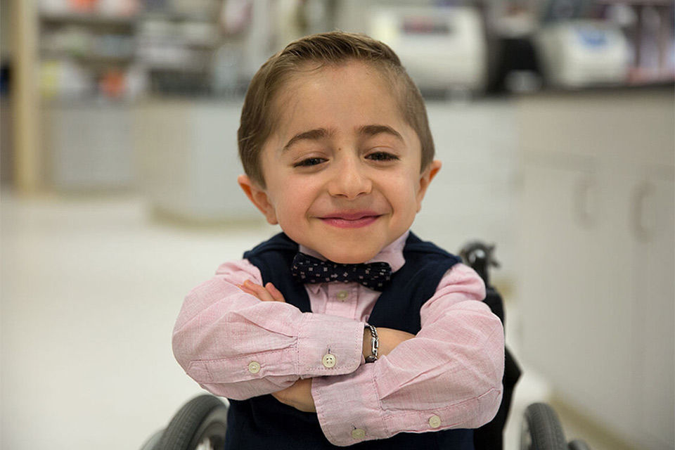 Kaleb poses with his arms crossed.