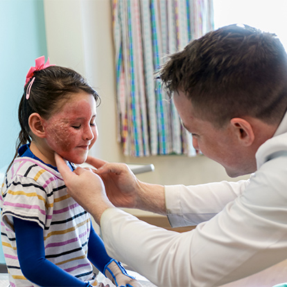 Female burn patient being examined by male doctor