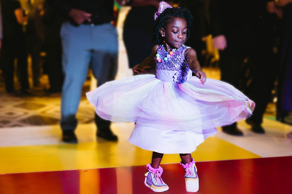 Young girl in pretty dress dancing